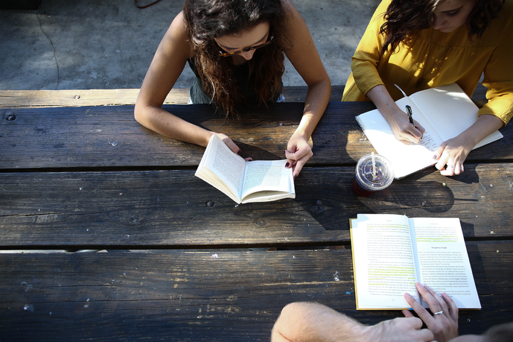 Students work together at a wood table