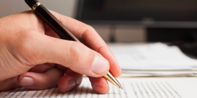 student writing with pen